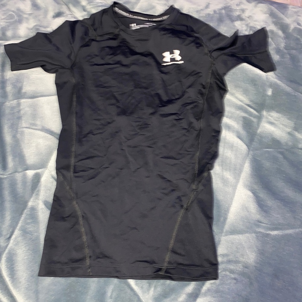 The brand of this t-shirt is under amor and is size small in men’s